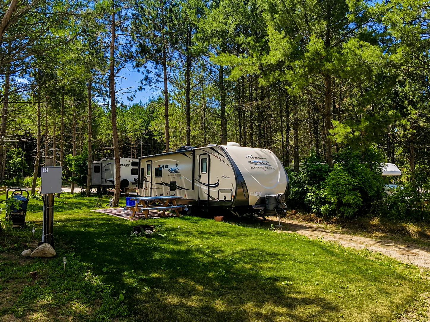 Trailers and RVs among the trees at Georgian Bay Park